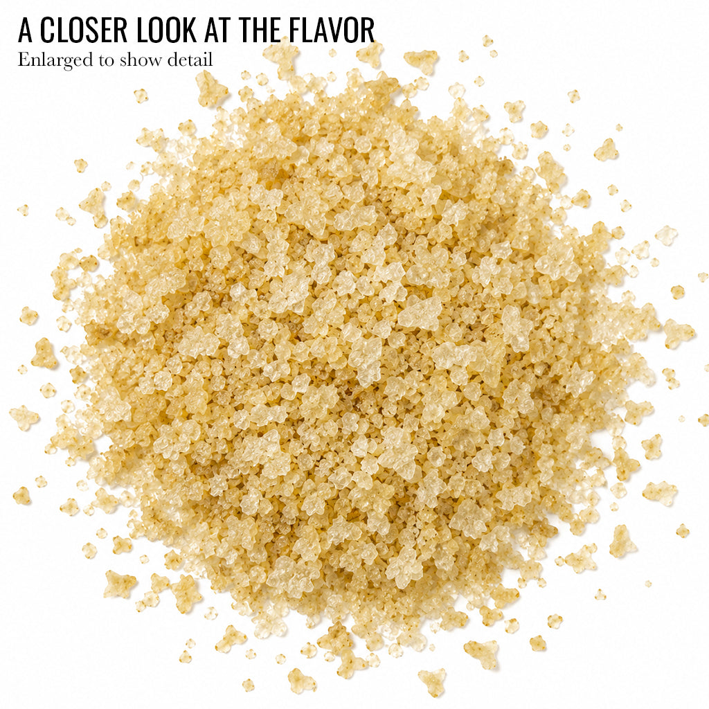 Close up of pale golden Roasted Garlic Infused Sea Salt crystals with the words A Closer Look at the Flavor