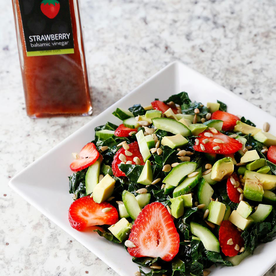 Strawberry Kale Salad with English cucumber, avocado and sunflower seeds with a light, flavorful vinaigrette made with Strawberry Balsamic Vinegar and Sicilian Lemon Infused Olive Oil. 