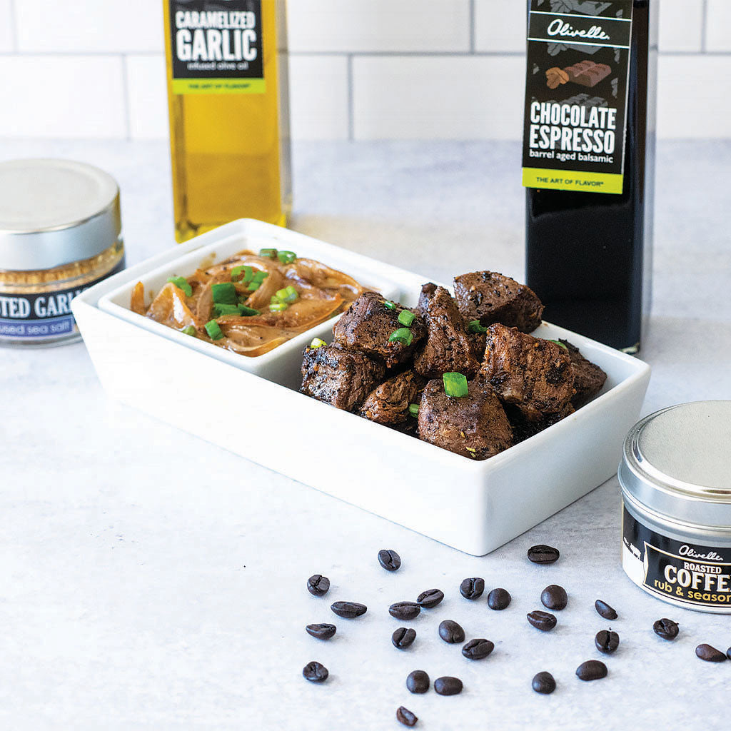 Coffee Rubbed Steak Tips seasoned with roasted coffee rub and roasted garlic sea salt. Sear it in caramelized garlic olive oil and garnish it with green onions. 