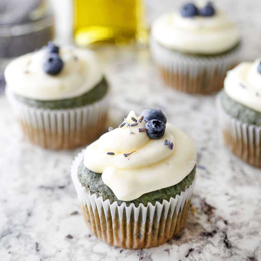 Lemon Olive Oil Cupcakes with Champagne frosting are made with Lemon Olive Oil and topped with a smooth and creamy frosting and blueberries.