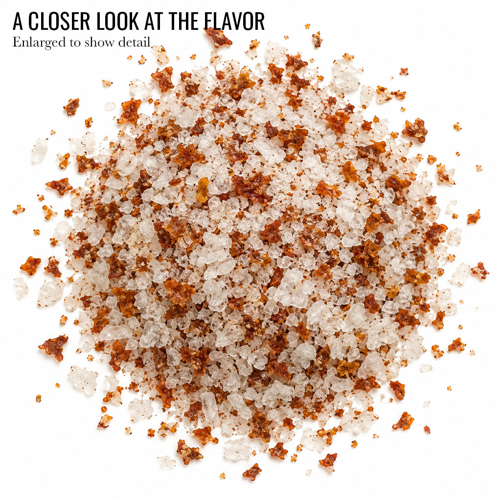 Close up of white salt flakes with red specks of Sriracha Flake Sea Salt with the words A Closer Look at the Flavor