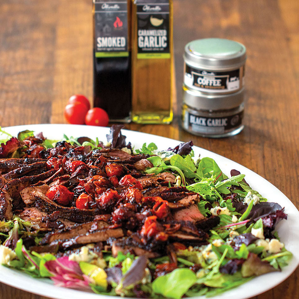 steak salad with greens, steak, tomatoes, baocn, blue cheese, and smoked balsamic dressing